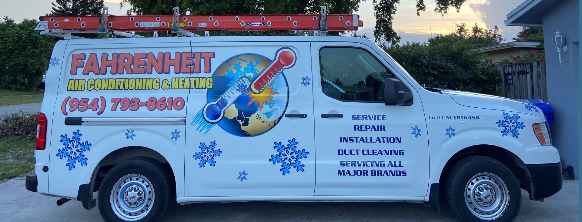The Fahrenheit AC service van wrapped with the company thermometer and globe branding, parked at a South Florida home.